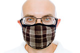 Bald man on a white background in the warm medical mask