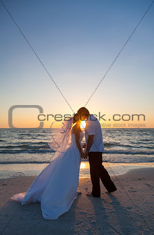 Bride and Groom Marriage Kissing Sunset Beach Wedding