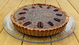 Freshly baked pecan pie on a glass plate