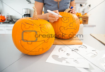 Woman creating pumpkins Jack-O-Lante for Halloween. Closeup