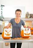 Woman with Halloween carving patterns preparing for party
