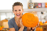 Portrait of woman with pumpkin Jack-O-Lantern for Halloween