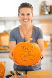 Woman holding pumpkin Jack-O-Lantern for Halloween. Closeup