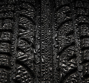 Close-up texture of tire with water drops 