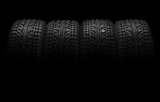 Car tires over black background