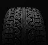 Tire with water drops over black background