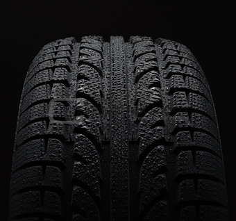 Tire with water drops over black background