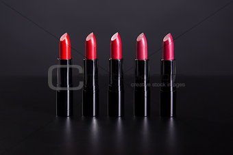 Set of bright lipsticks in shades of red color  