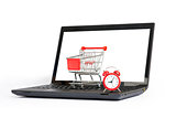 Shopping cart, alarm clock on laptop, close view