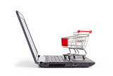 Shopping cart on laptop, close up view