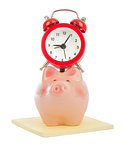Alarm clock on piggy bank