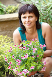 happy smiling middle age woman gardening