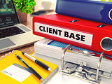 Client Base on Red Office Folder. Toned Image.