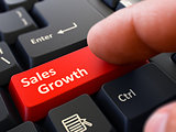 Press Button Sales Growth on Black Keyboard.