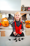 Funny girl in halloween bat costumein with mouse toys