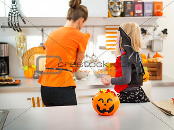 Closeup on halloween pumpkin bucket full of candy on table