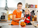 girl in halloween bat costume spending time with mother
