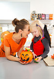 Portrait of happy mother with daughter in halloween bat costume