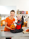 Portrait of girl in halloween bat costume with mother