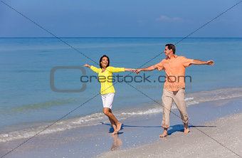 Happy Couple Running Holding Hands on A Beach