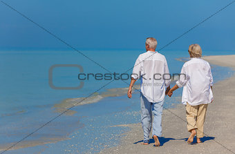 Senior Couple Holding Hands Walking on Beach
