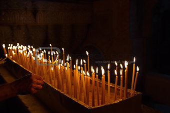 Rows of burning candles .