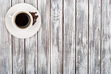 Cup of coffee and coffee beans  on wooden background