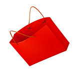 red shopping bag in the air on an isolated white background