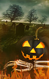 Black pumpkin with skeleton hand with graveyard