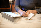 Woman taking down information in notebook