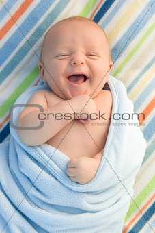 Laughing Baby Boy Wrapped in His Blanket