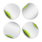 Set of white round stickers with green backside.