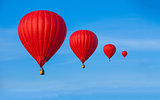 Red balloons in sky
