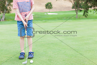 boy playing golf