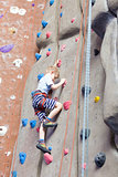 boy rock climbing