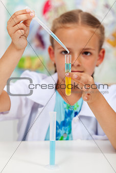 Little girl experimenting in chemistry class