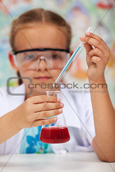 Young student in chemistry class doing an experiment