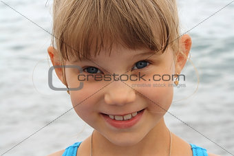 portrait of smiling little funny blonde girl