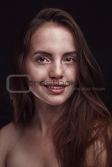 smiling woman with long hair and freckles