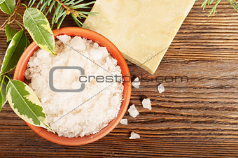 Salt and soap on a wooden background