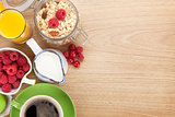 Healty breakfast with muesli, berries, orange juice, coffee and 