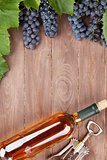 Wine bottle and grapes on garden table