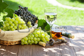 Wine and grape on garden table