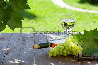 Wine and grape on garden table