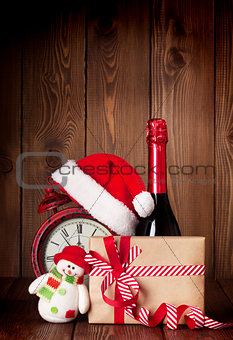 Christmas gift box, alarm clock and champagne