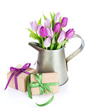 Purple tulip bouquet in watering can and gifts