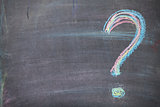 Colorful chalk question mark on blackboard background