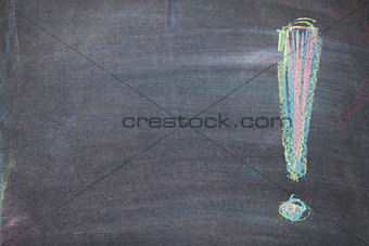 Colorful chalk exclamation mark on blackboard background