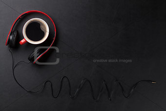 Headphones and coffee cup on desk