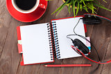 Blank notepad, headphones and coffee